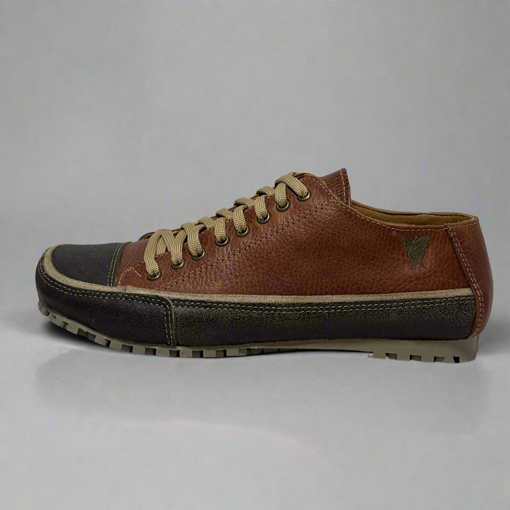 Brown leather sneaker with black sole on a white background