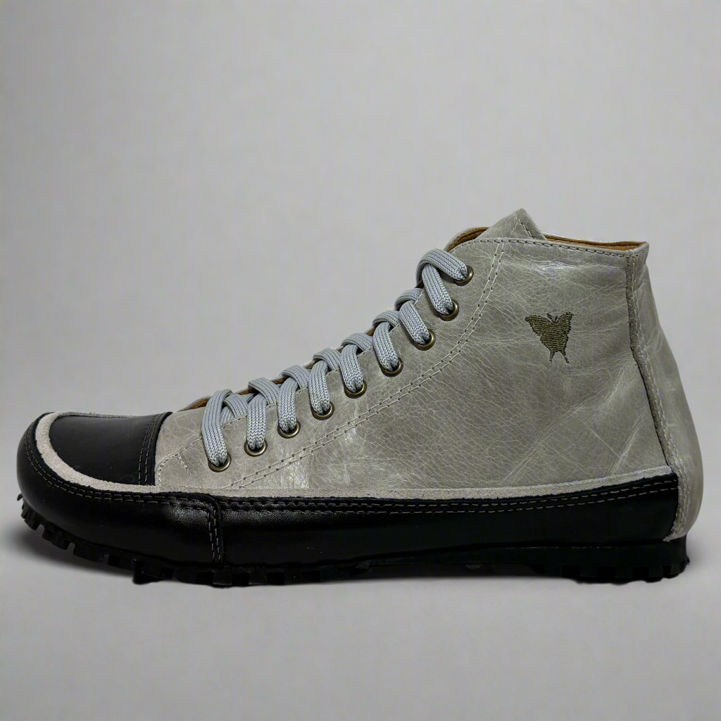 Gray high-top sneaker with black sole on a textured white background