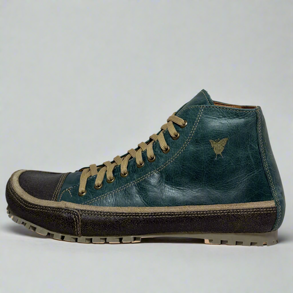 Blue leather boot with brown laces on a white background