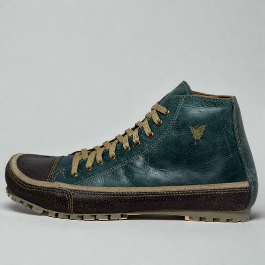 Blue leather boot with brown laces on a white background