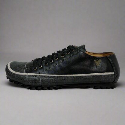 Dark gray sneaker with white sole on a light gray background
