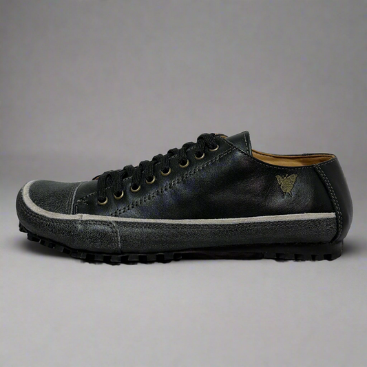 Dark gray sneaker with white sole on a light gray background